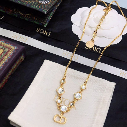 CD 26S CD LOGO CRYSTAL STATION NECKLACE IN GOLD TONE METAL WITH WHITE CRYSTAL 631006