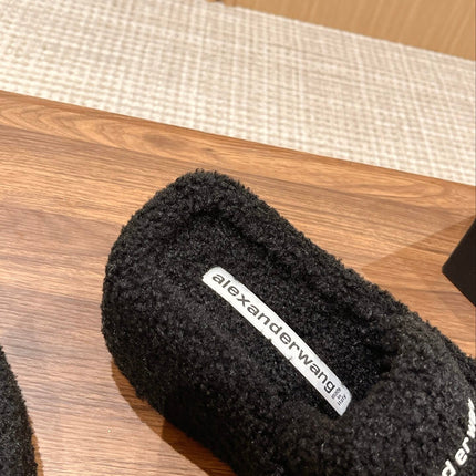 CHUNKY PLATFORM SIPPERS IN BLACK LAMBSWOOL