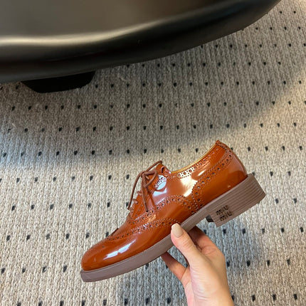 MIUMIU 26S LACE-UP BROGUE LOAFERS IN RUST ORANGE PATENT CALFSKIN