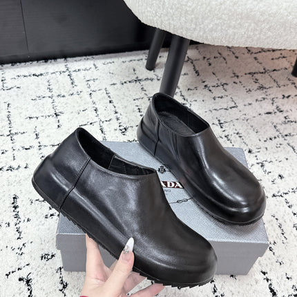 PRADA 26S SLIP ON SHOES IN BLACK SMOOTH CALFSKIN