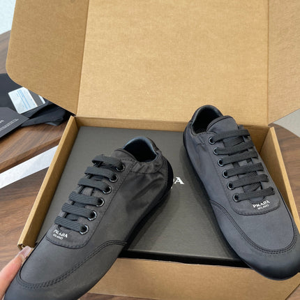 PRADA 25S SNEAKER IN BLACK SILK