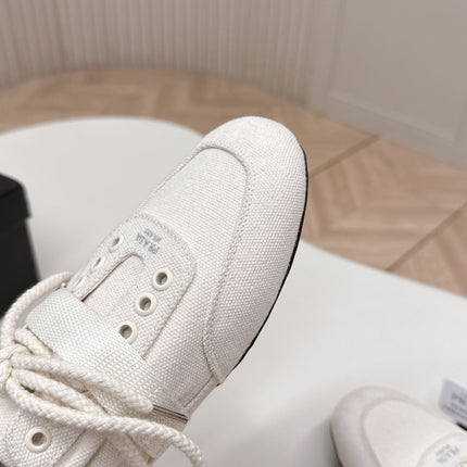 PRADA 26S LACE UP MINIMAL SNEAKERS IN WHITE CANVAS