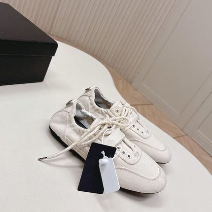 PRADA 26S LACE UP MINIMAL SNEAKERS IN WHITE CANVAS