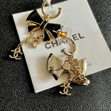 CHANEL 26S DOUBLE C LOGO BLACK ENAMEL BOW DANGLE EARRINGS WITH CHAIN CHARMS IN GOLD METAL 629178