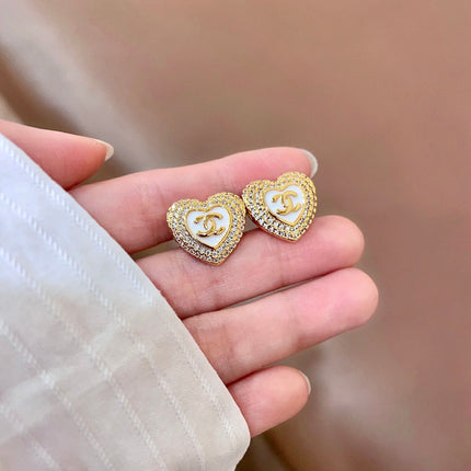 CHANEL 26S DOUBLE C LOGO PAVE HEART STUD EARRINGS WITH WHITE ENAMEL IN GOLD METAL 631815