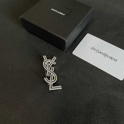 YSL 26S CRYSTAL LOGO BROOCH IN SILVER TONE METAL 634974