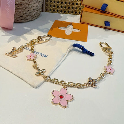 SAKURA BAG CHARM IN GOLD METAL HARDWARE