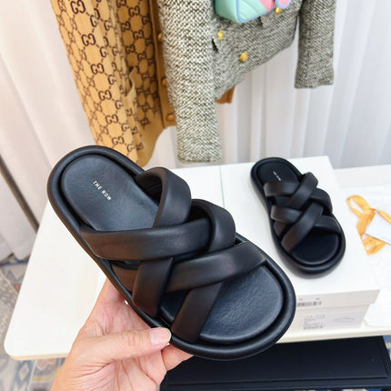 THE ROW 26S CROSSED PADDED SLIDES IN BLACK CALFSKIN