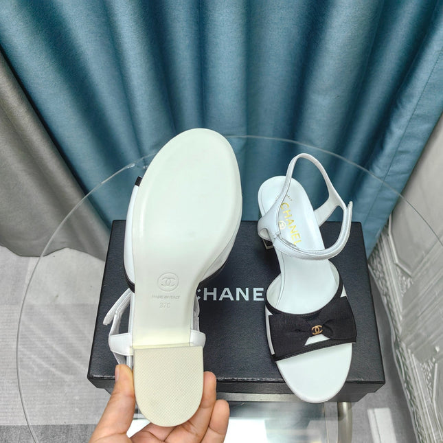 SANDALS IN WHITE SHEEPSKIN WITH BLACK SATIN BOW