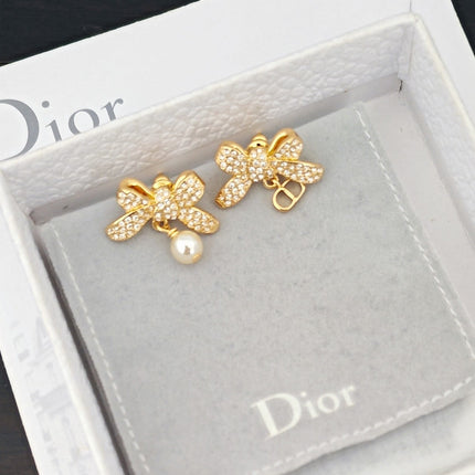 CD 26S CRYSTAL BOW PEARL DROP EARRINGS IN GOLD TONE METAL 644377