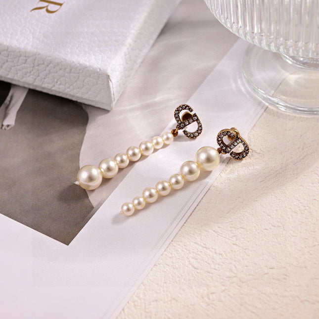 CD 26S PAVE LOGO PEARL DROP EARRINGS IN GOLD TONE METAL 631791