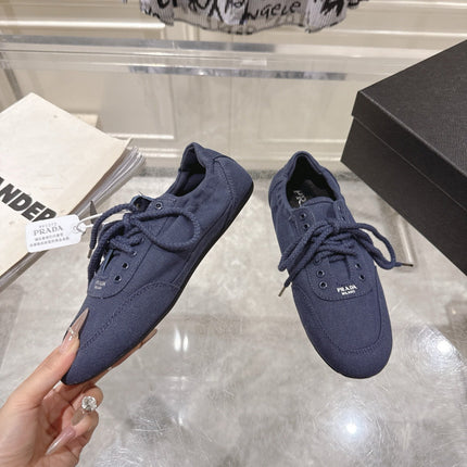 PRADA 26S COLLAPSE SNEAKERS IN BLUE CANVAS