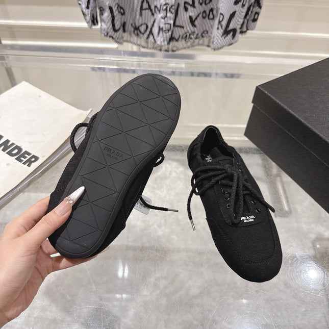 PRADA 26S COLLAPSE SNEAKERS IN BLACK CANVAS