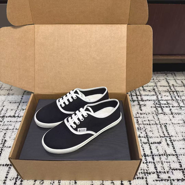 PRADA 26S LACE UP SNEAKERS IN BLACK AND WHITE CANVAS